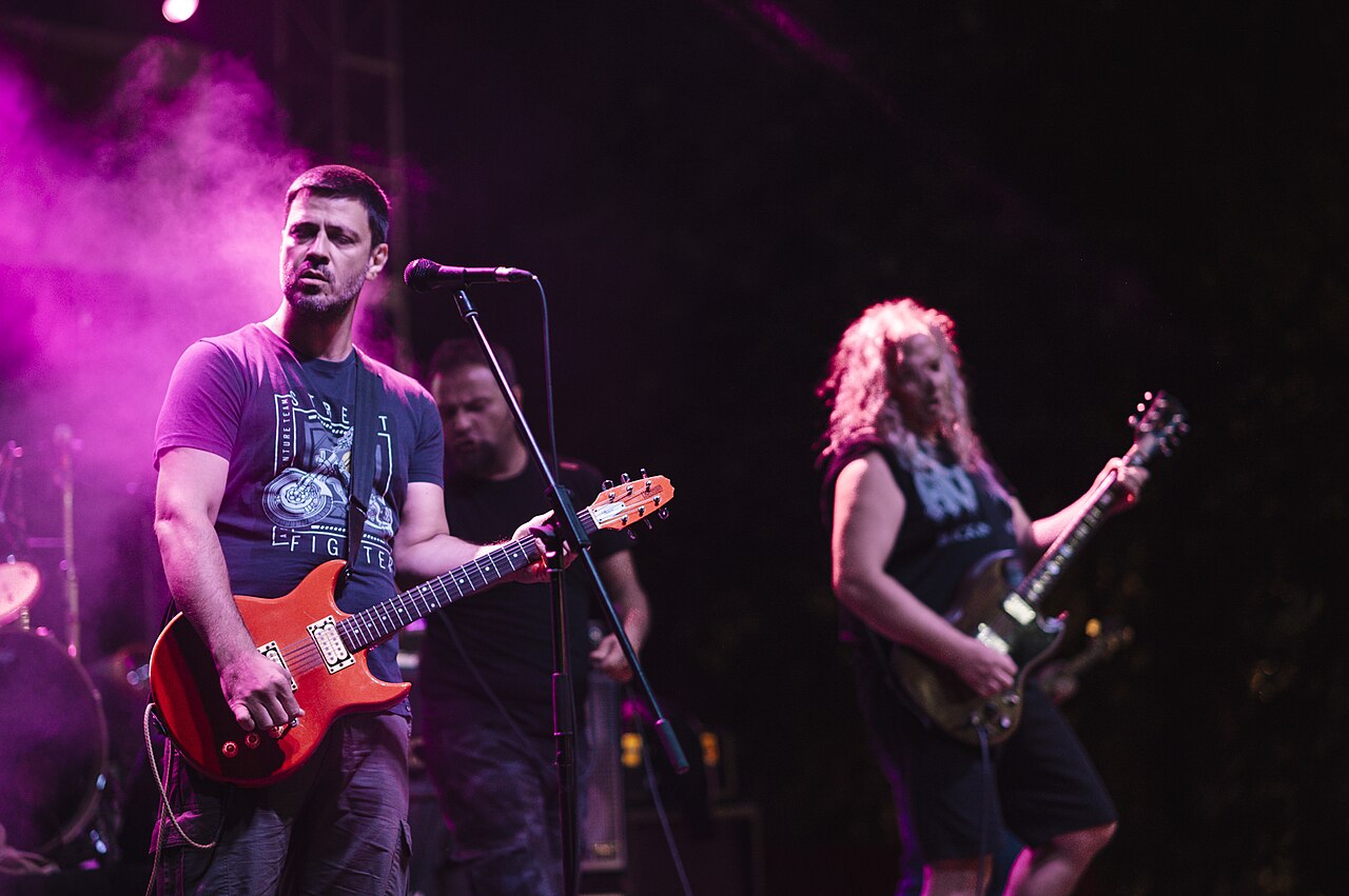 File:Live band performs energetic rock music at a vibrant outdoor festival during the evening.jpg — illustrative image